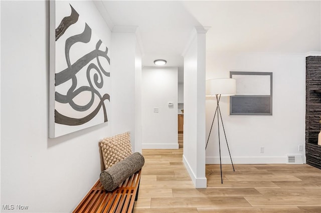 hall with crown molding and wood-type flooring