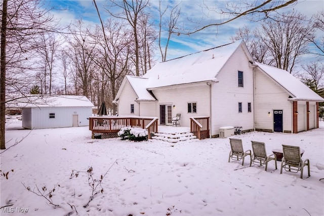 snow covered property with a wooden deck