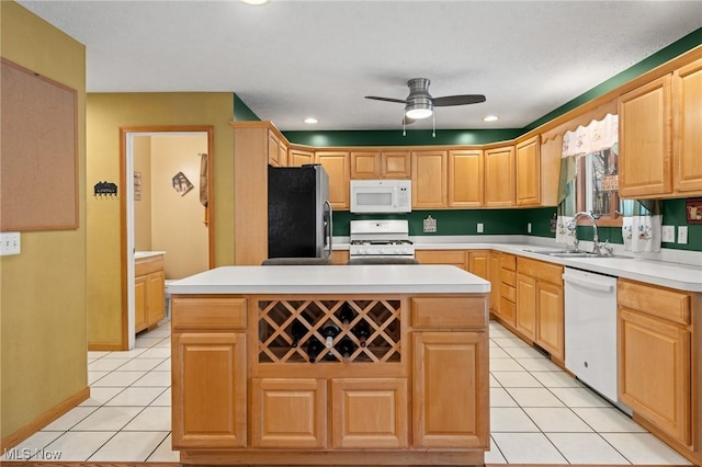 kitchen with white appliances, a sink, a ceiling fan, light tile patterned floors, and light countertops