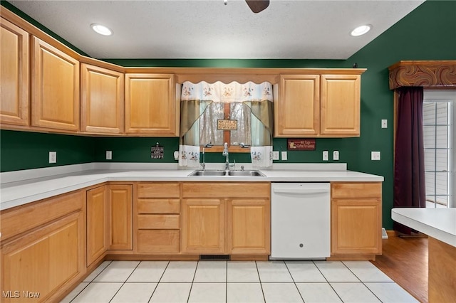 kitchen featuring white dishwasher, ceiling fan, light tile patterned flooring, and sink