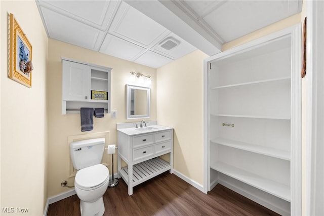 bathroom with wood finished floors, baseboards, toilet, and vanity