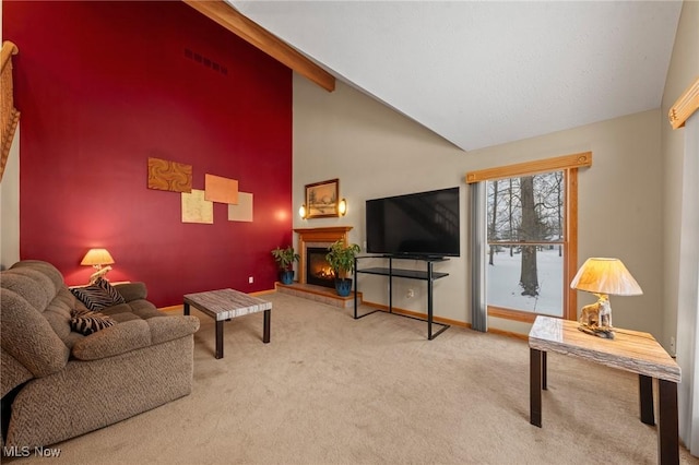 carpeted living room featuring baseboards, a lit fireplace, and high vaulted ceiling