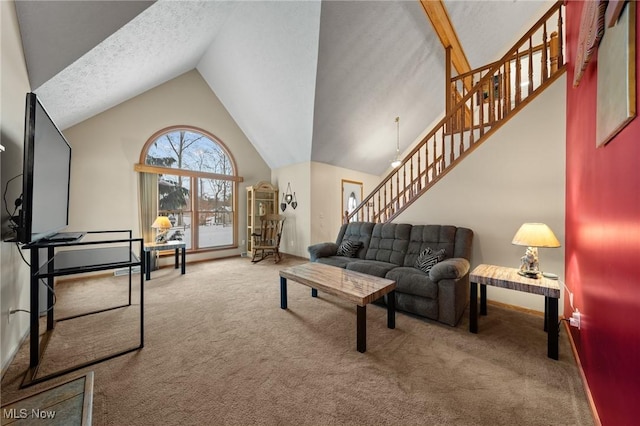 carpeted living room featuring a textured ceiling, a chandelier, and vaulted ceiling