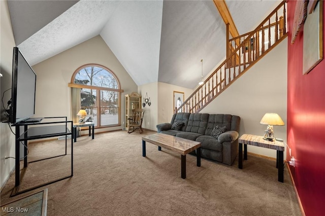 carpeted living area with stairway and vaulted ceiling