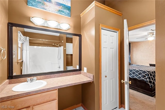 bathroom with a shower, vanity, and ceiling fan