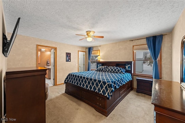 bedroom with a textured ceiling, light colored carpet, and ceiling fan