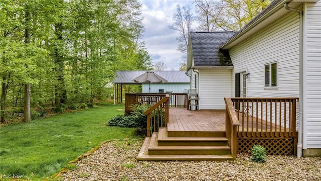 wooden deck featuring a yard