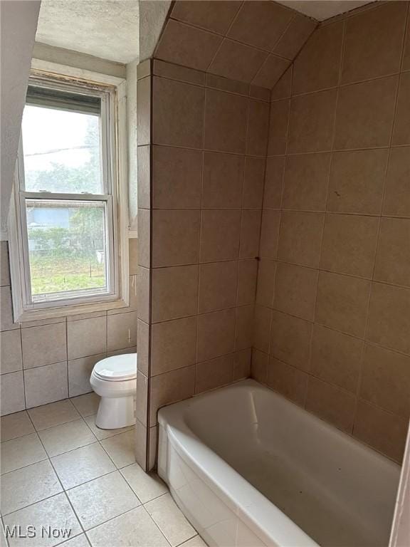 bathroom featuring tile patterned floors, a textured ceiling, vaulted ceiling, and toilet