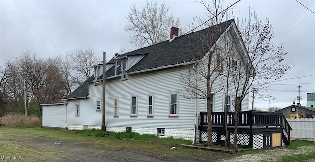 view of side of property with a deck