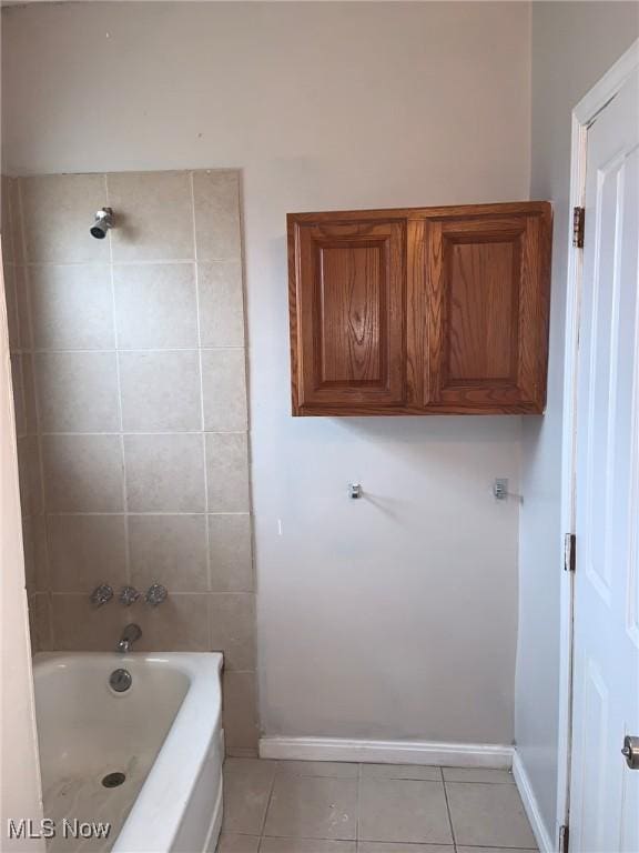 bathroom with tile patterned floors and tiled shower / bath combo