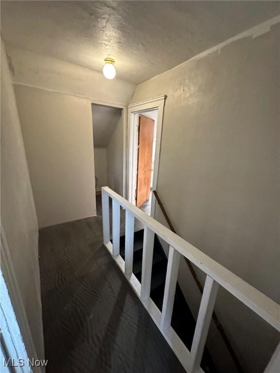 stairway featuring lofted ceiling