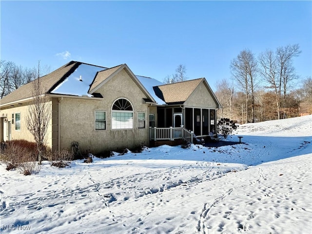 view of front of house featuring a sunroom