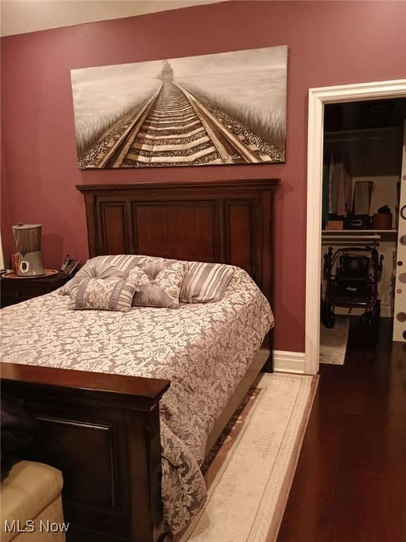 bedroom with a closet and wood-type flooring