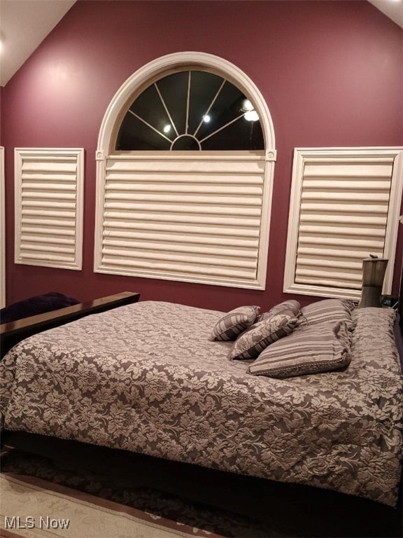 unfurnished bedroom with lofted ceiling