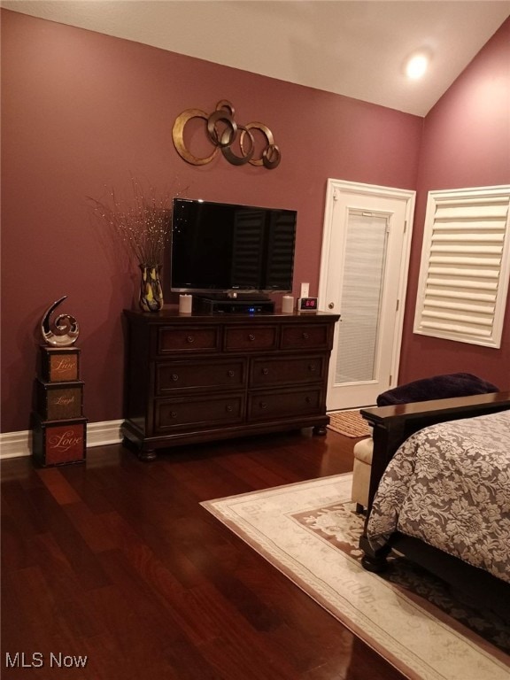 bedroom featuring lofted ceiling and dark wood-type flooring