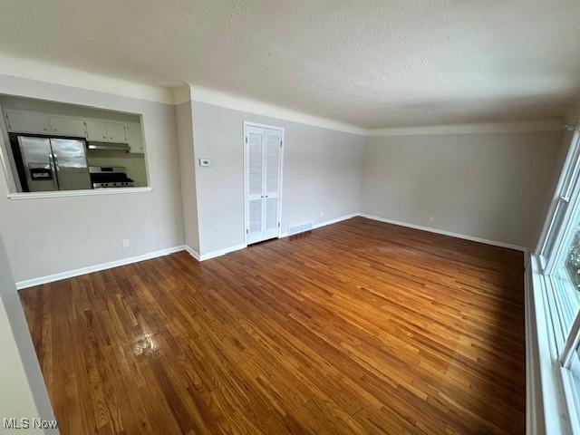 empty room featuring dark wood-type flooring