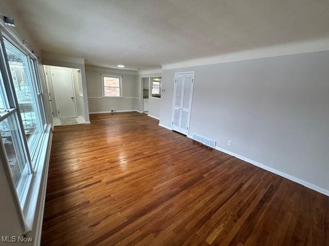 unfurnished room with dark wood-type flooring