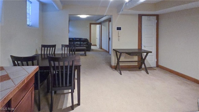 dining area featuring light carpet