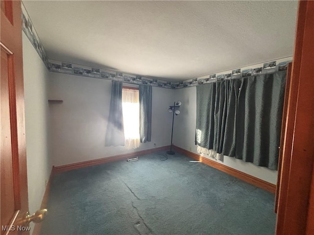 unfurnished room featuring dark carpet