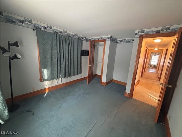 unfurnished bedroom featuring dark colored carpet