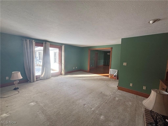 unfurnished room with a textured ceiling