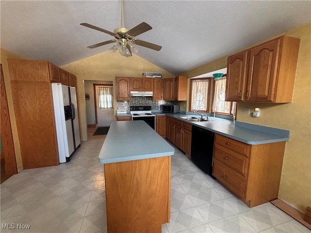 kitchen featuring white appliances, sink, vaulted ceiling, ceiling fan, and a kitchen island