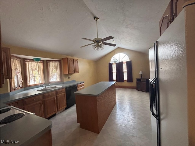 kitchen featuring dishwasher, sink, vaulted ceiling, a kitchen island, and fridge with ice dispenser