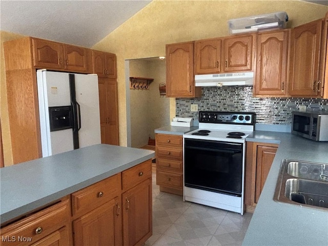 kitchen with decorative backsplash, white appliances, sink, and vaulted ceiling