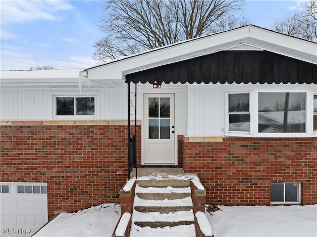 view of snow covered property entrance