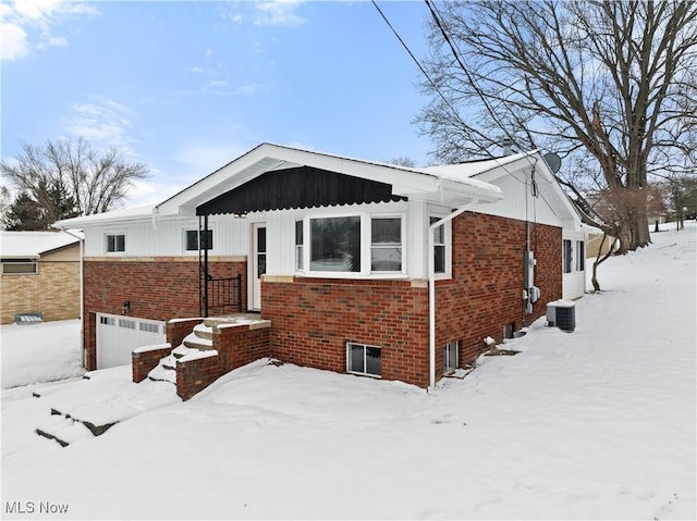 view of front of property with cooling unit and a garage