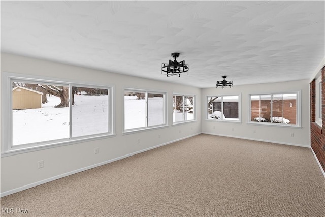 unfurnished sunroom with a notable chandelier