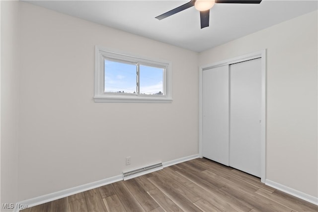 unfurnished bedroom featuring ceiling fan, light hardwood / wood-style flooring, and a closet