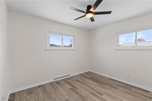 unfurnished room with light hardwood / wood-style flooring and ceiling fan