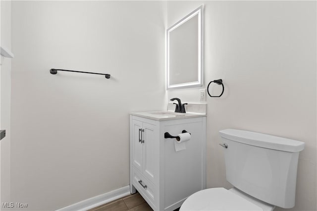 bathroom featuring tile patterned flooring, vanity, and toilet