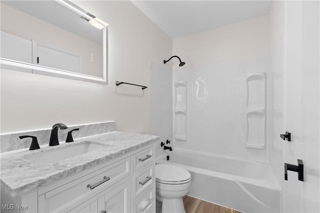 full bathroom featuring vanity, wood-type flooring, tub / shower combination, and toilet