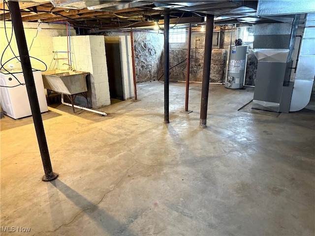 basement with gas water heater, sink, washer / clothes dryer, and heating unit