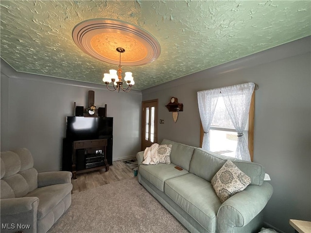 carpeted living room with a textured ceiling and an inviting chandelier