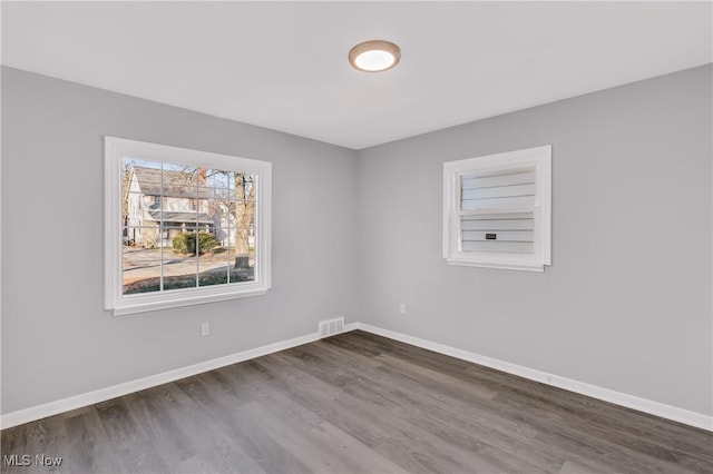 spare room featuring dark wood-type flooring