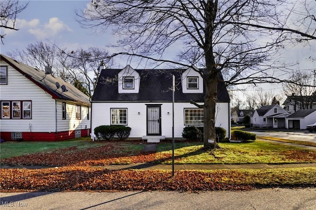 new england style home with a front yard