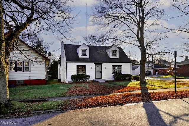 new england style home with a front yard