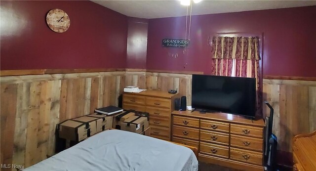 bedroom with wooden walls