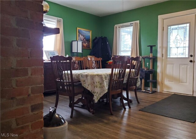 dining space with wood-type flooring