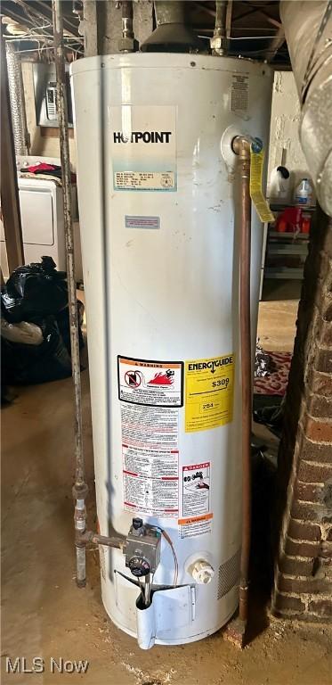 utilities featuring gas water heater and washer / dryer