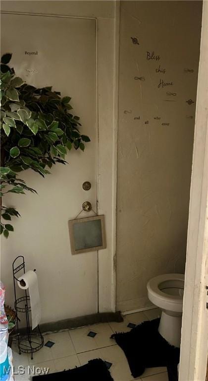 bathroom with tile patterned floors and toilet