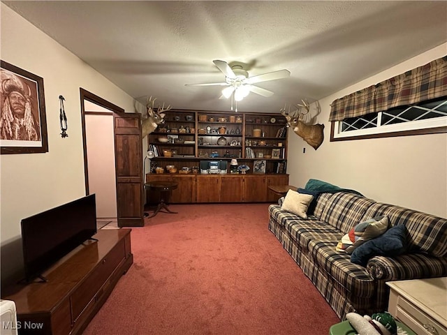 carpeted living room with ceiling fan