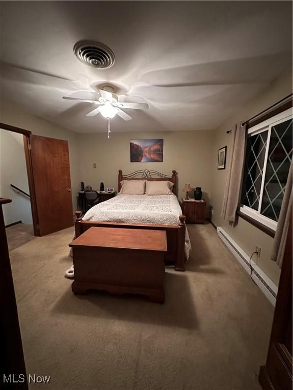 bedroom featuring carpet flooring, baseboard heating, and ceiling fan