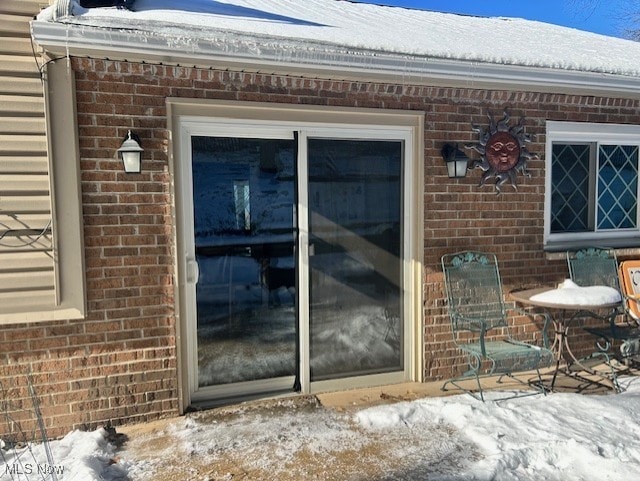 view of snow covered property entrance