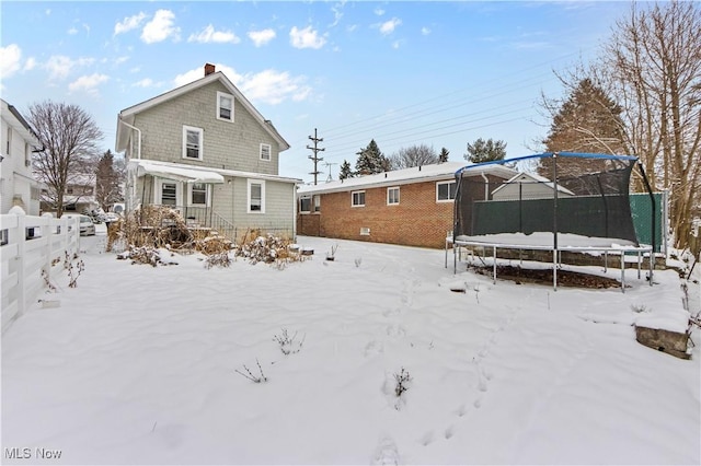 snow covered property featuring a trampoline