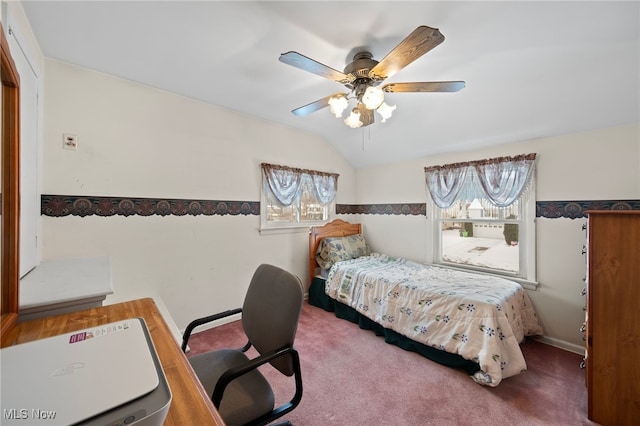 carpeted bedroom with ceiling fan and vaulted ceiling