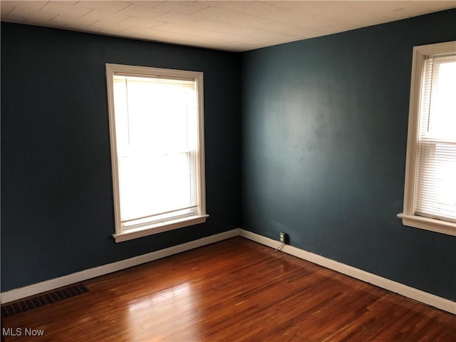 empty room with hardwood / wood-style flooring